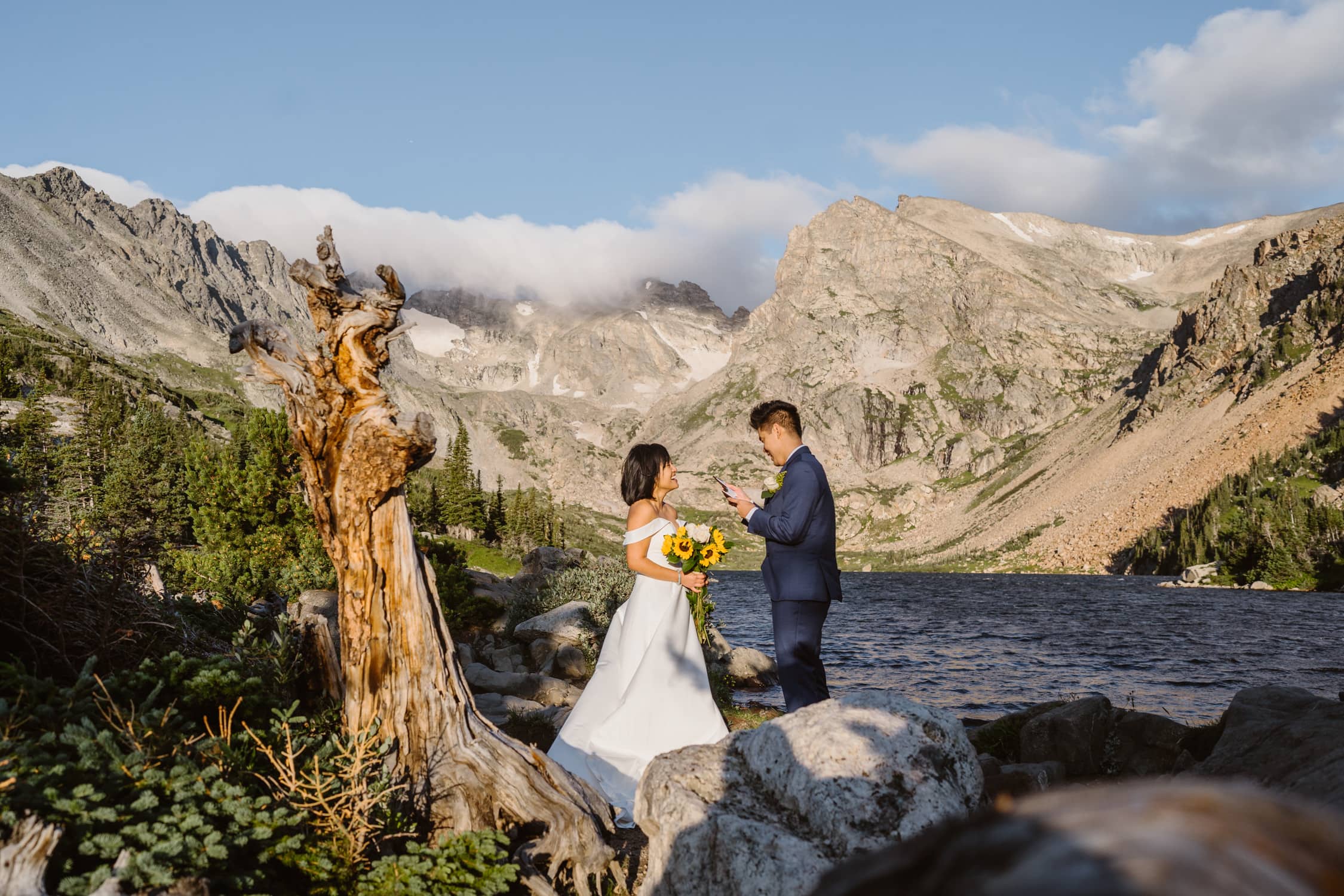 A couple sharing their vows at sunrise at Lake Isabelle in Colorado
