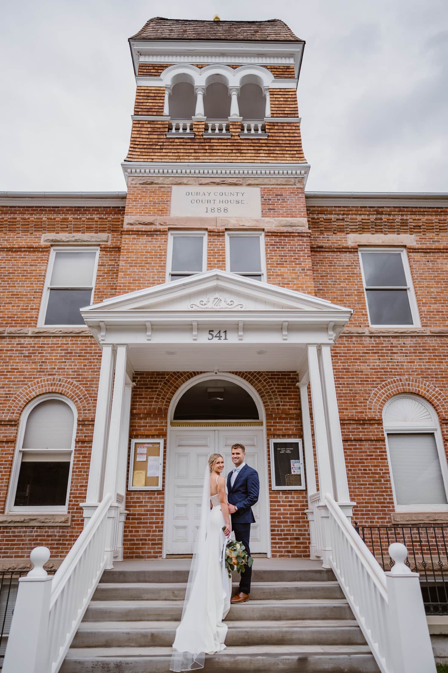 Couple posing on the courthouse steps in Ouray, Colorado.