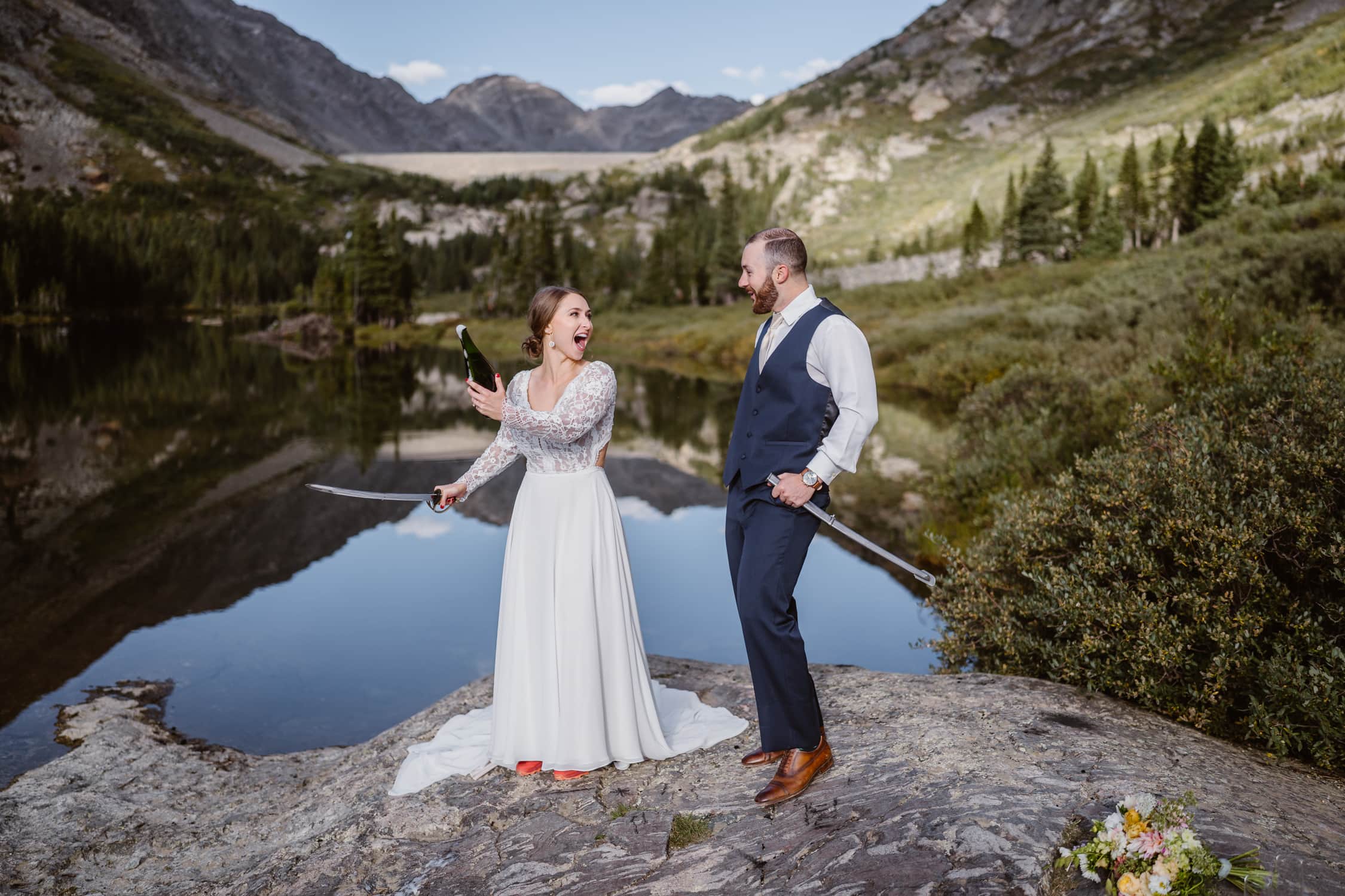 Husband and wife sabering champagne bottle on their elopement in Breckenridge.