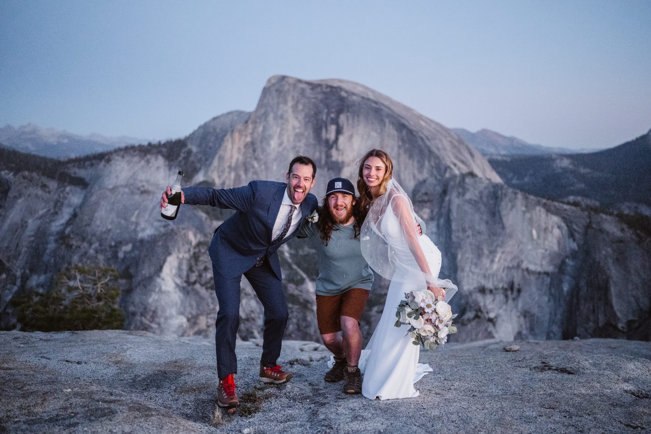 A couple with their elopement photographer in Yosemite.