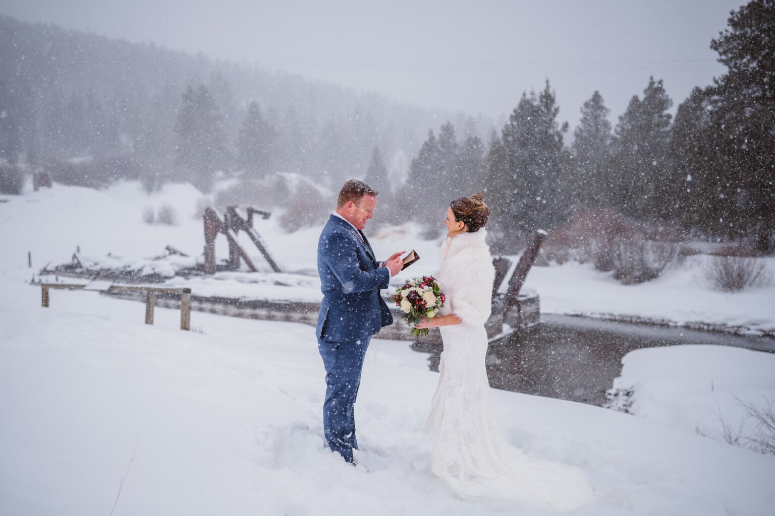 A couple sharing their vows in the snow storm after their Self-Solemnization.