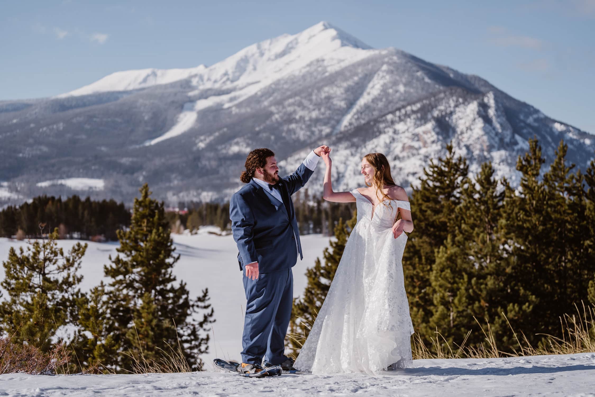 A couple sharing a first dance in the snow during their Breckenridge elopement.