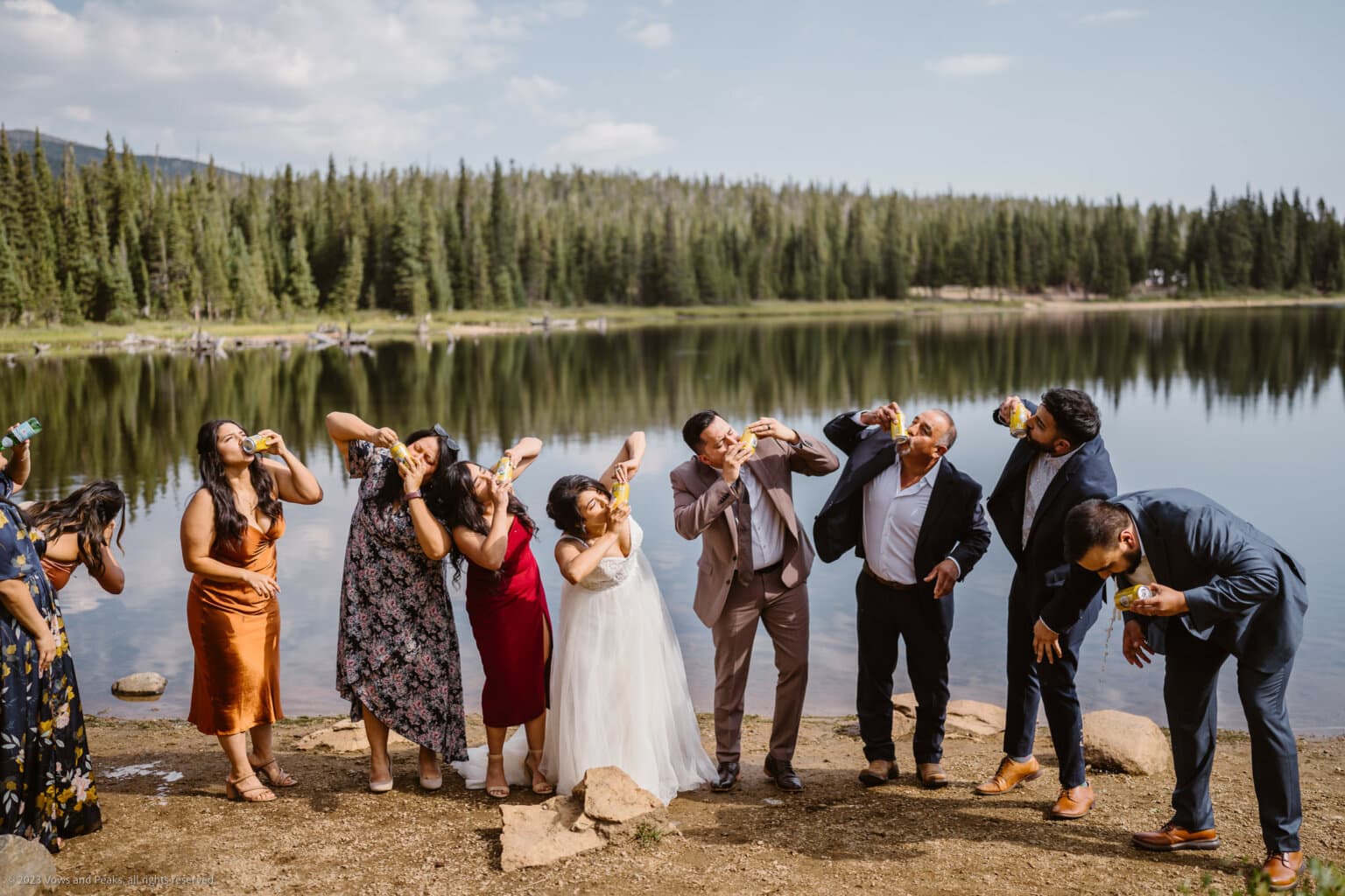 Couple shotgunning beers with their family for their elopement activity.