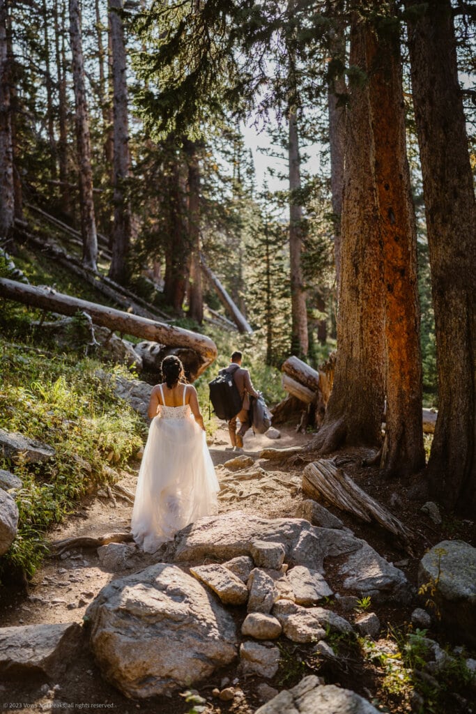 Couple hiking down for their Lake Isabelle elopement.