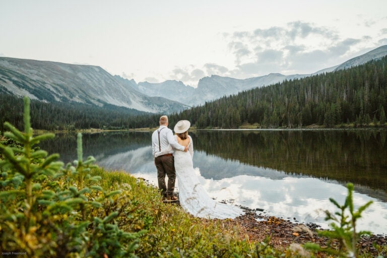 Couple near some reflections for their Lake Isabelle elopement.