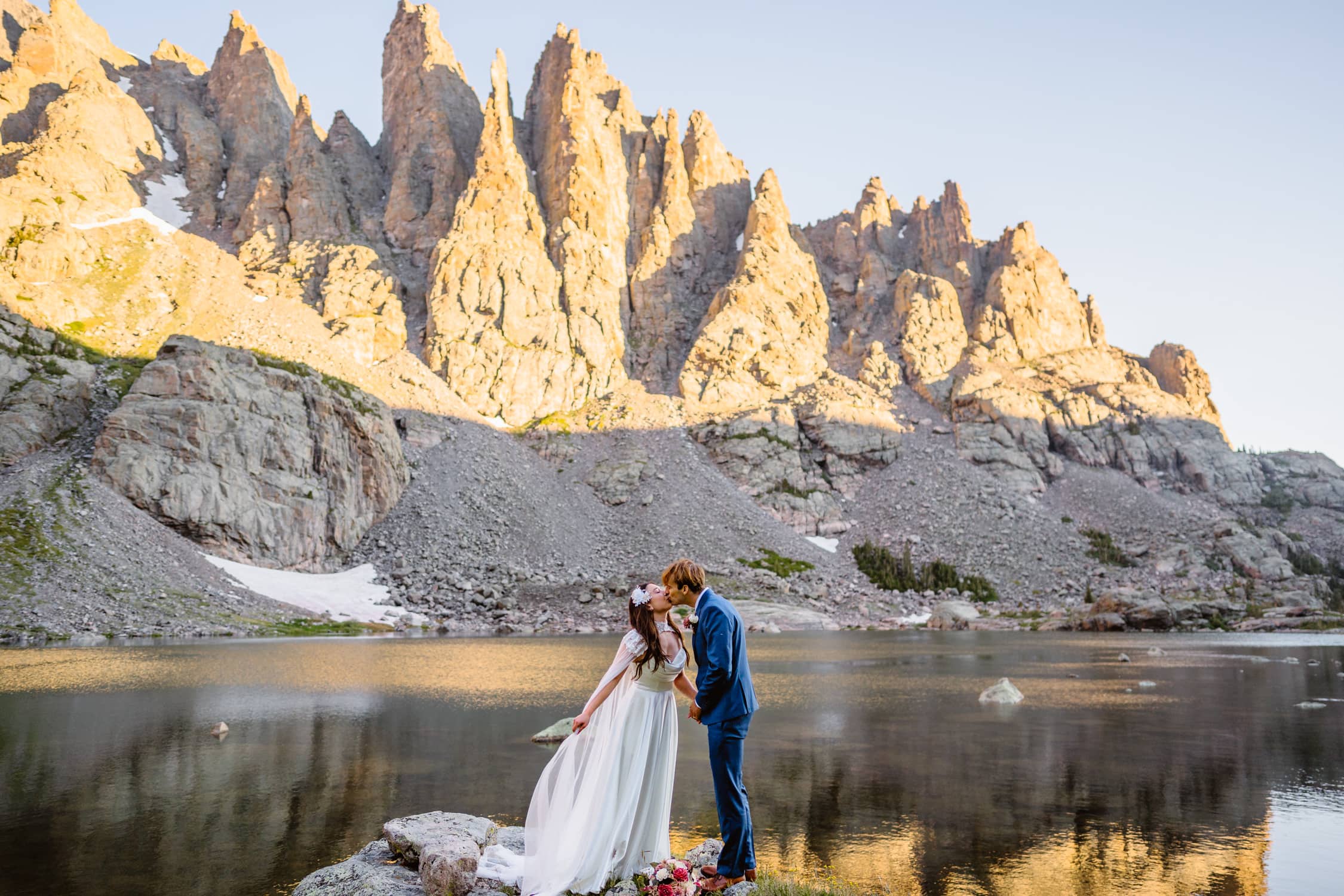 A couple sharing a kiss on their elopement at sunrise.