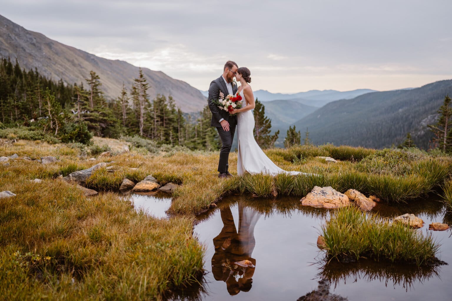 A couple sharing a moment near a tarn in the mountains of Colorado.