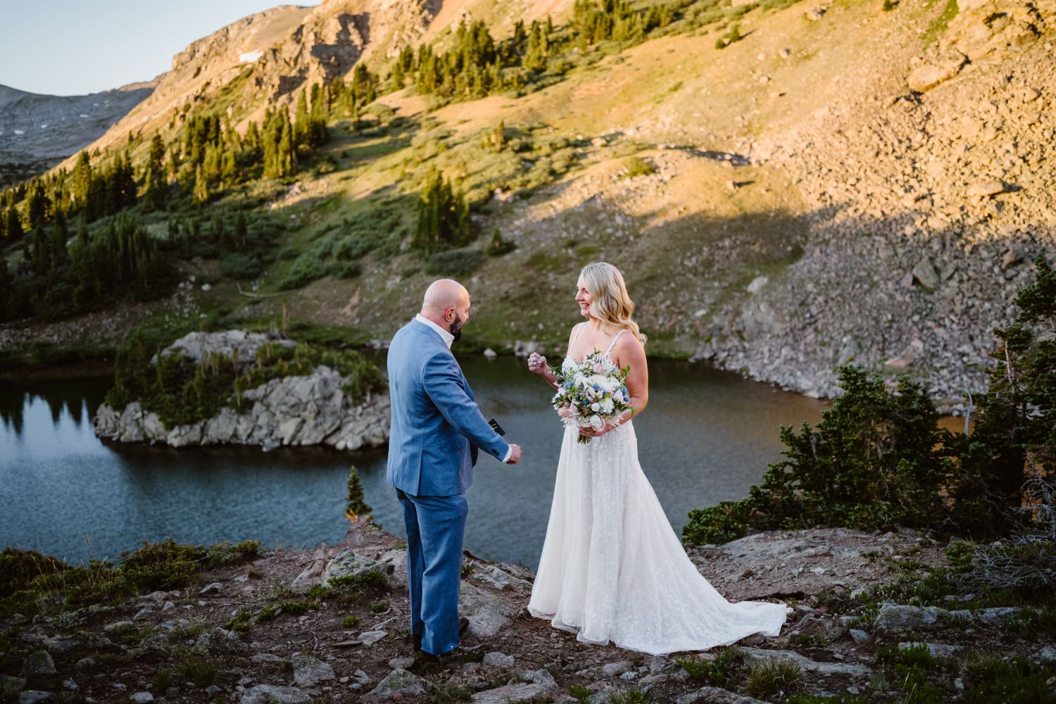 A couple sharing their vows at sunrise near an alpine lake in Buena Vista, Colorado.