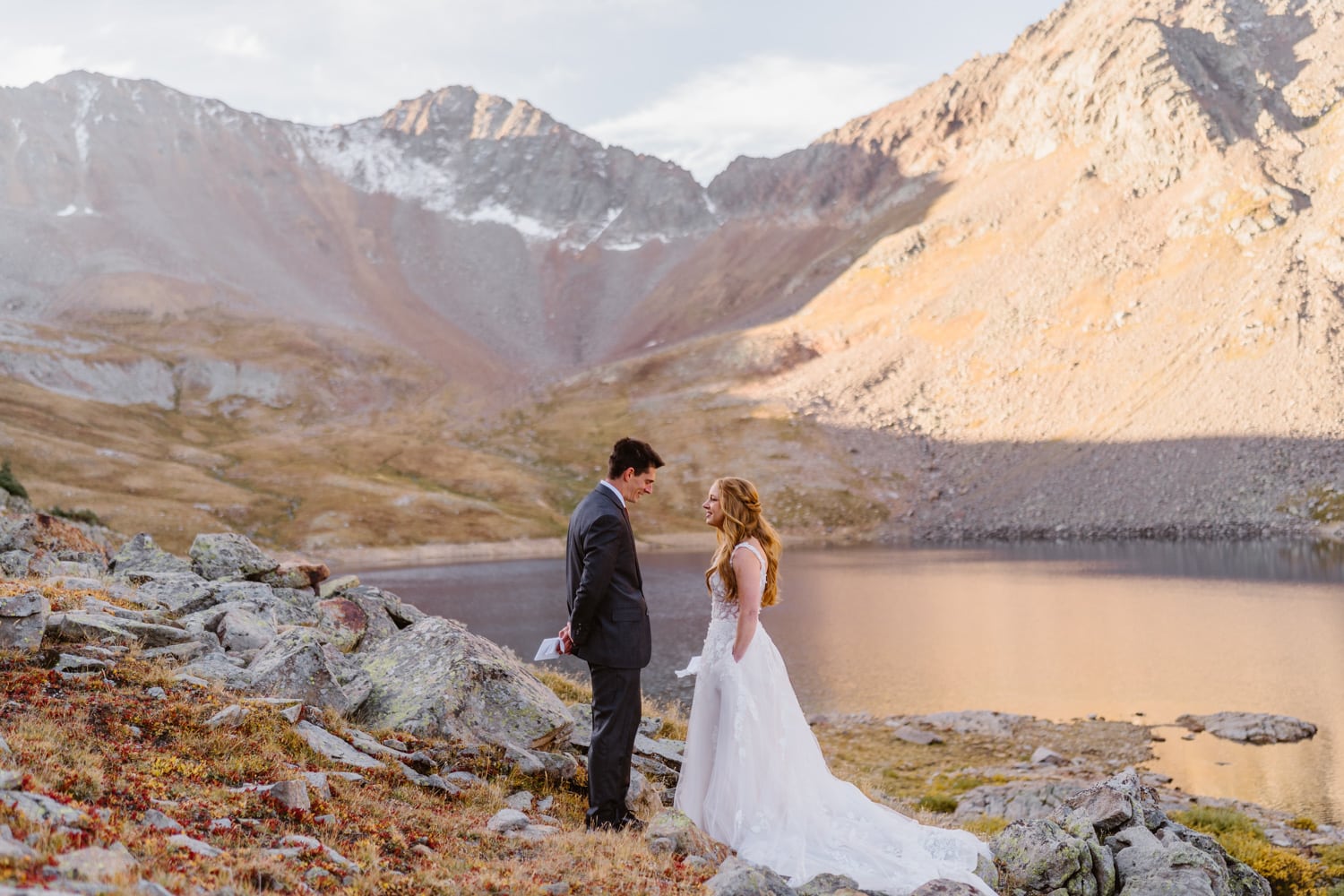 A couple sharing their vows at an alpine lake in Colorado for their Self-Solemnization.