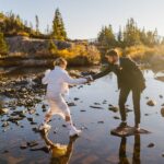 Couple hiking over rocks for their Colorado elopement.