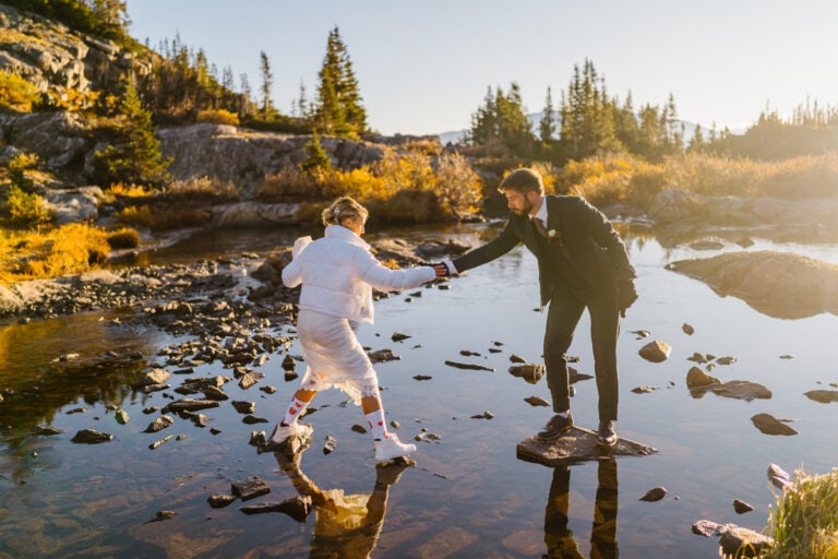 Couple hiking across rock for their Breckenridge elopement.