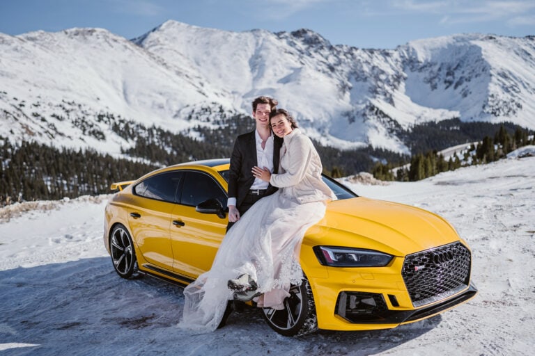 Couple sitting on their car for their Breckenridge elopement.