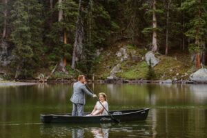 Couple using a canoe after eloping in the mountains of Colorado.
