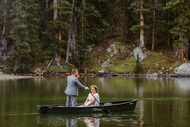 Couple rowing canoe at an alpine lake near Telluride, Colorado.