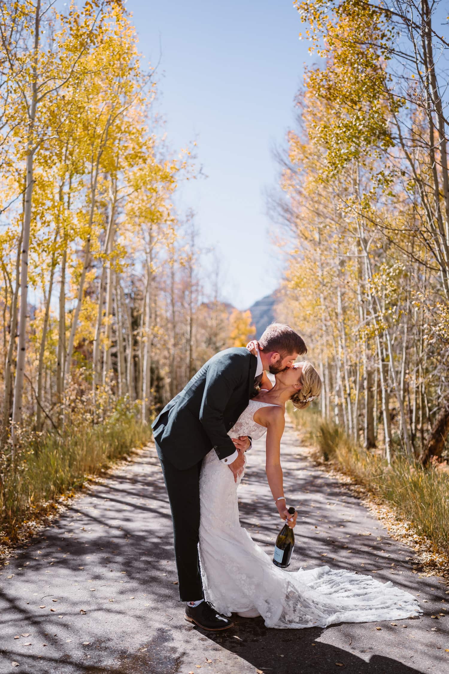 Couple spraying champagne for their Breckenridge, Colorado elopement.