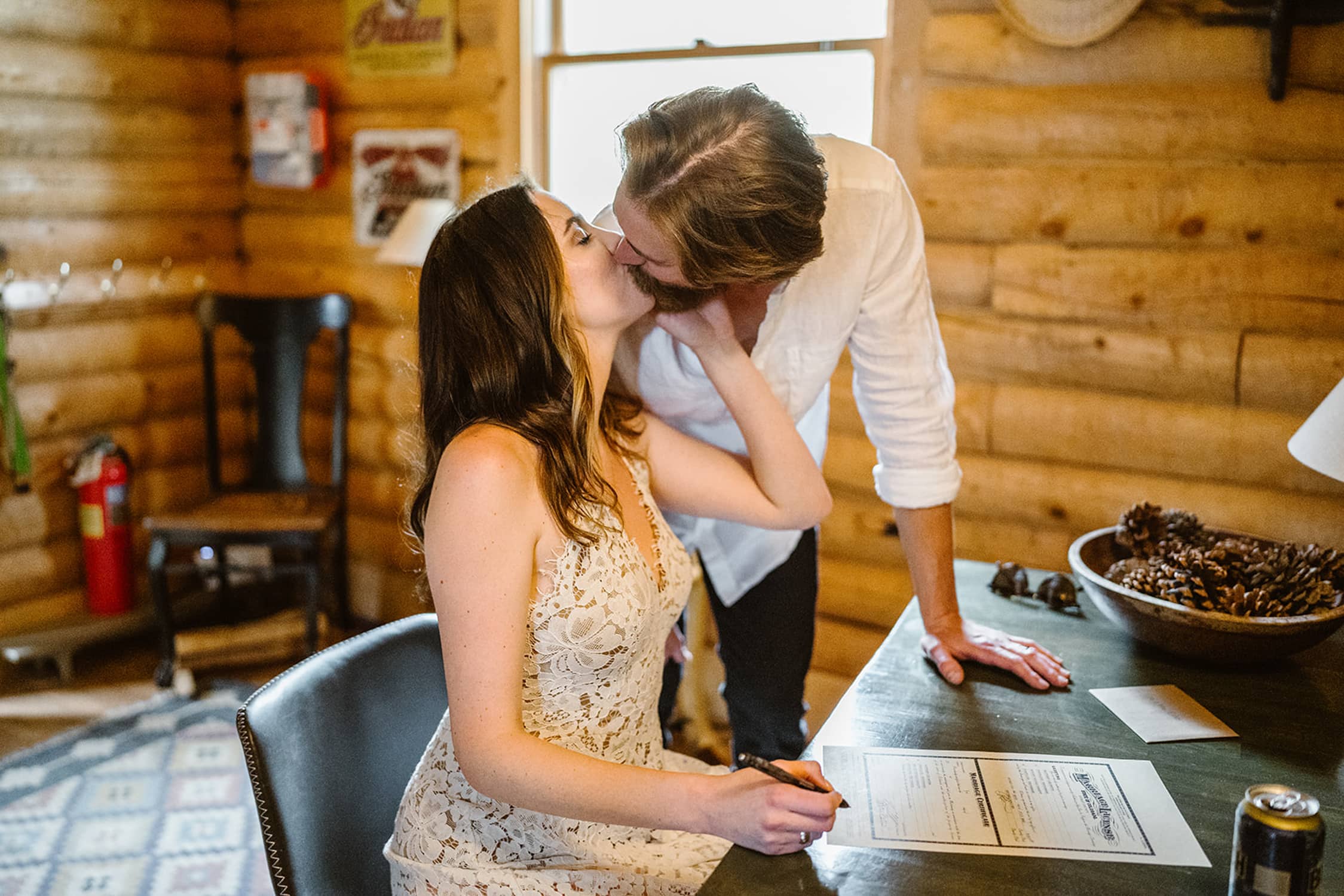 Couple signing their license at their airbnb elopement.