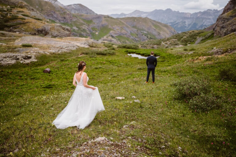 Bride hiking down to share a first look with her husband at her Colorado elopement.