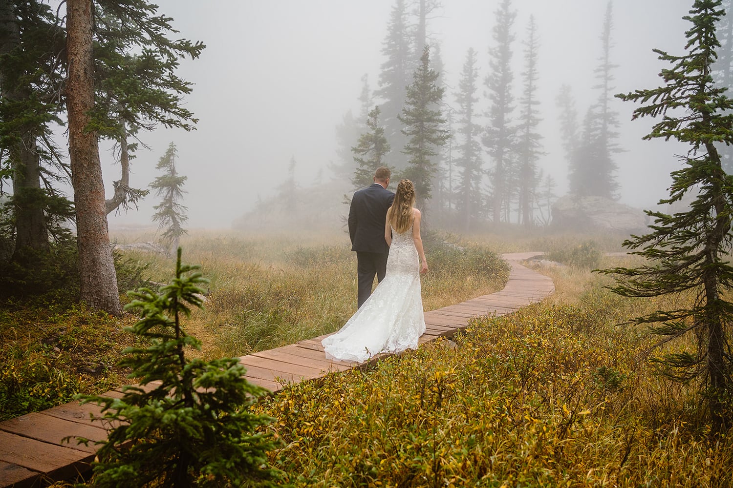 Couple hiking in the mist at their Rocky Mountain National Park elopement.