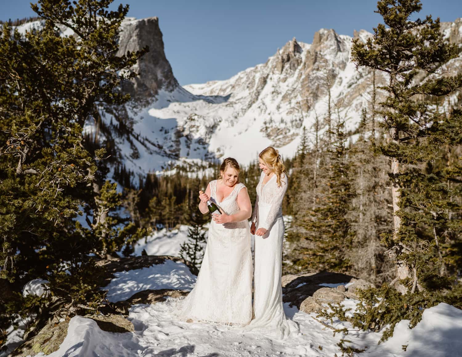 LGBTQ Couple spraying champagne at their Rocky Mountain National Park elopement.