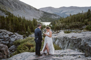 Bride and groom sharing vows on a rock in Colorado.