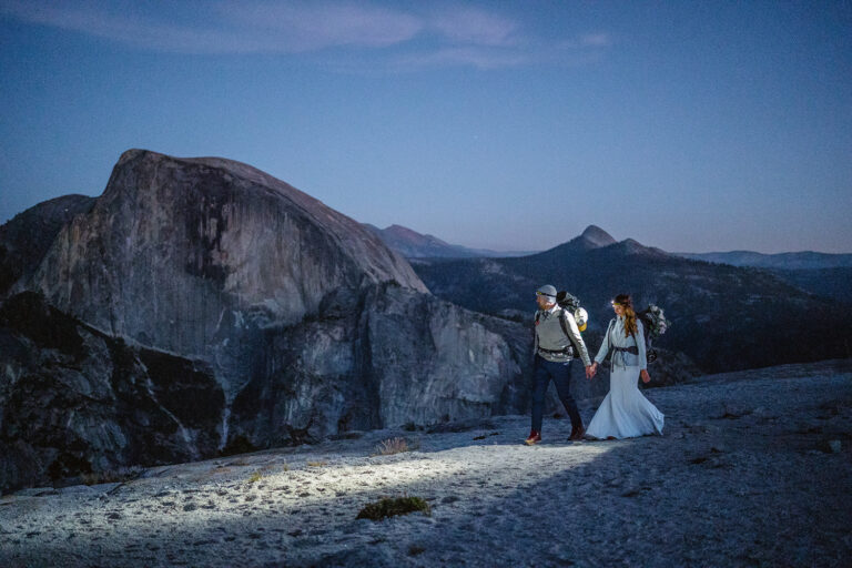 Couple walking under the stars near half dome for their Yosemite elopement