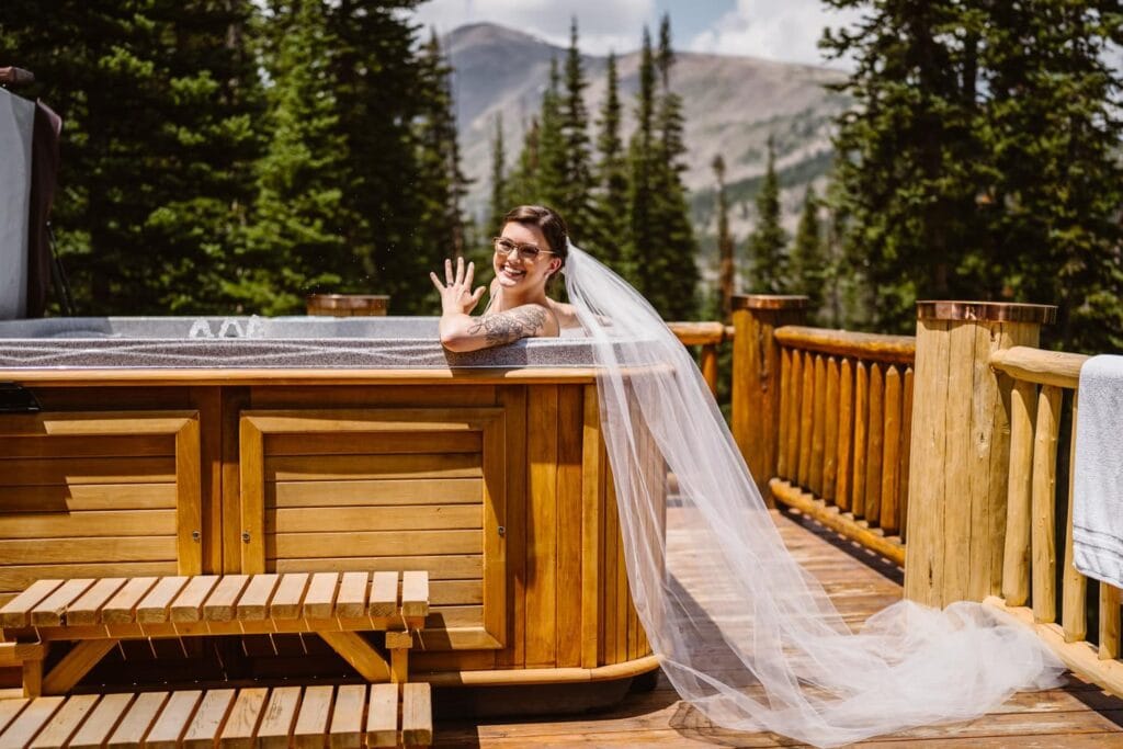 Bride in a hot tub at her airbnb elopement.