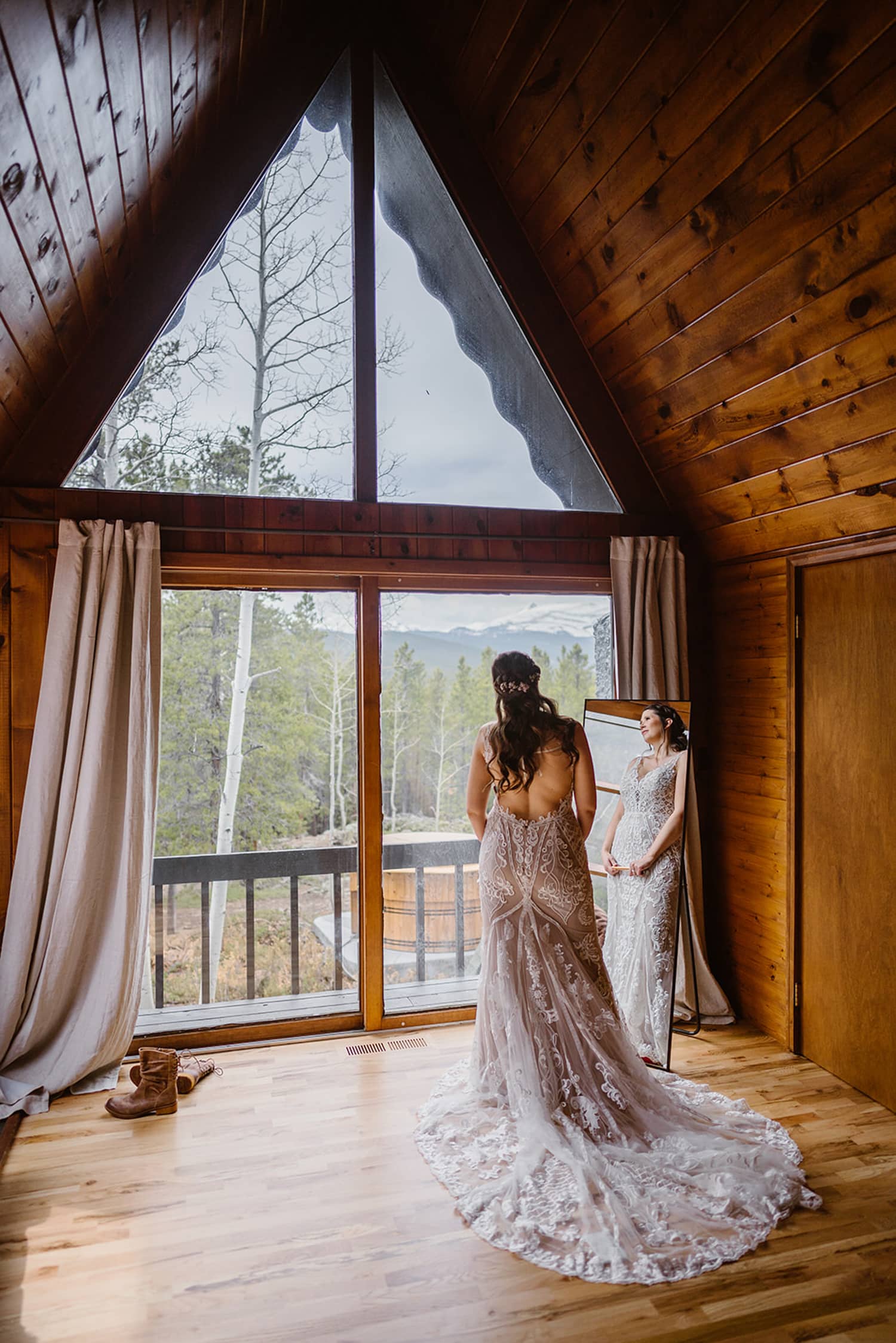 Bride looking out window at her airbnb elopement.