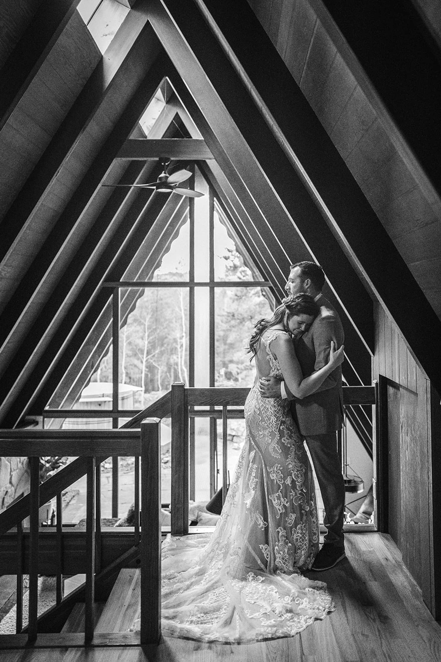 Bride and groom standing on the stairs at their airbnb elopement.