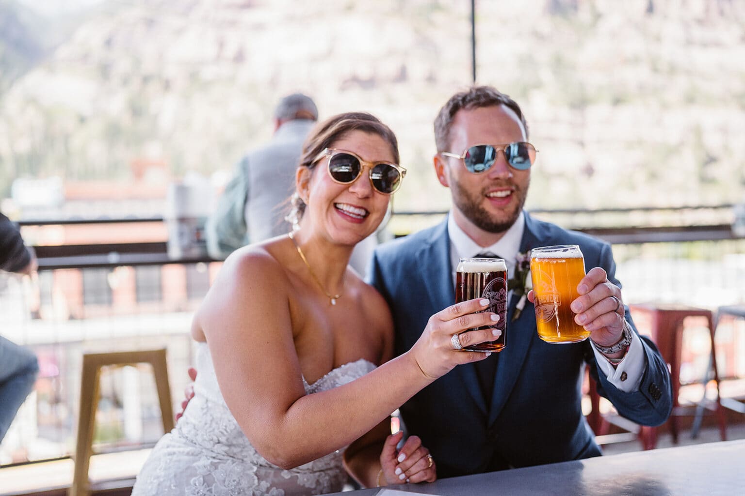 Couple drinking beers for their elopement activity.