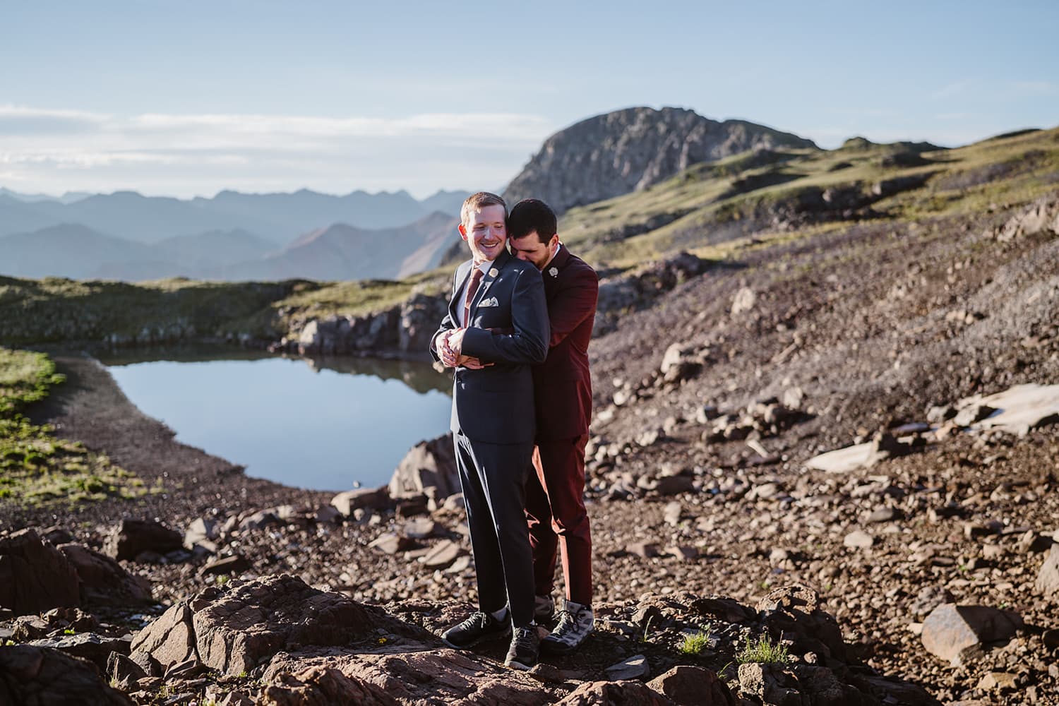 Two grooms hugging at their off roading elopement.