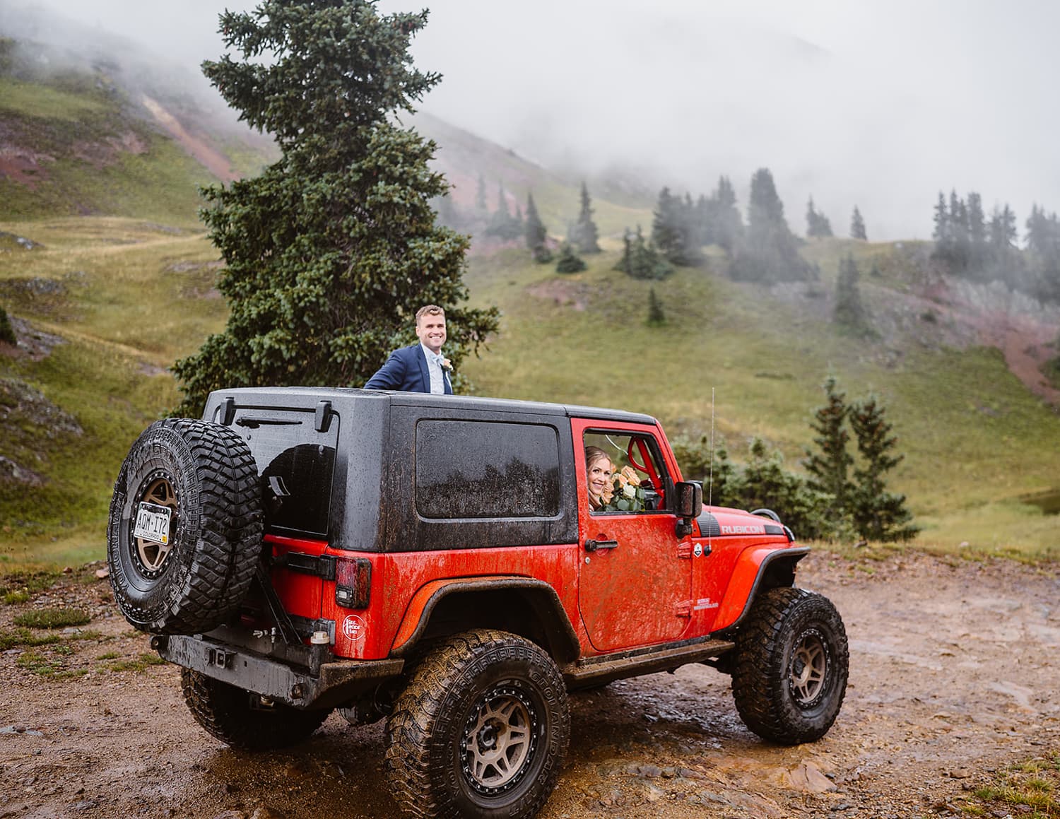 Couple sharing a smile at their jeep for their off roading elopement. 