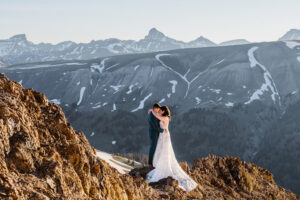Couple standing on rock for their elopement in Colorado.