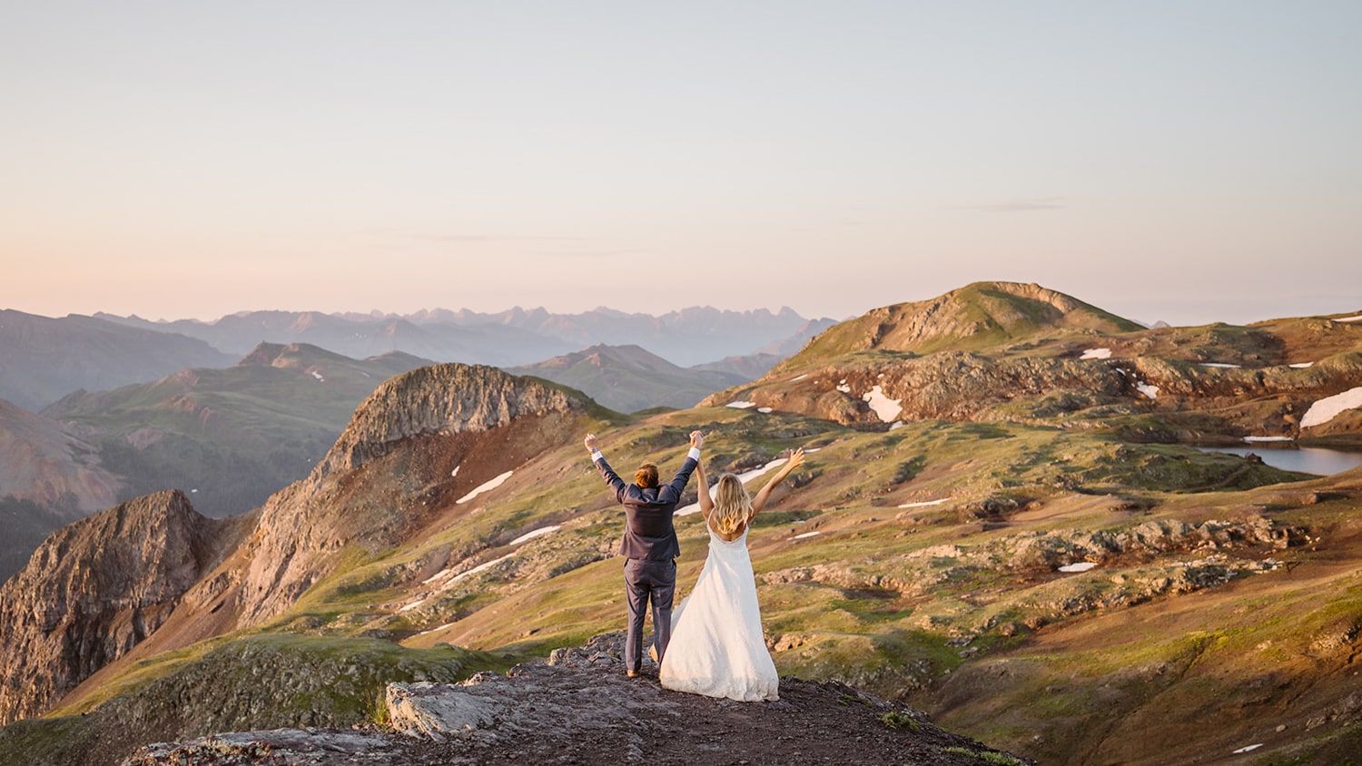 Couple celebrating up a mountain at their off roading elopement.