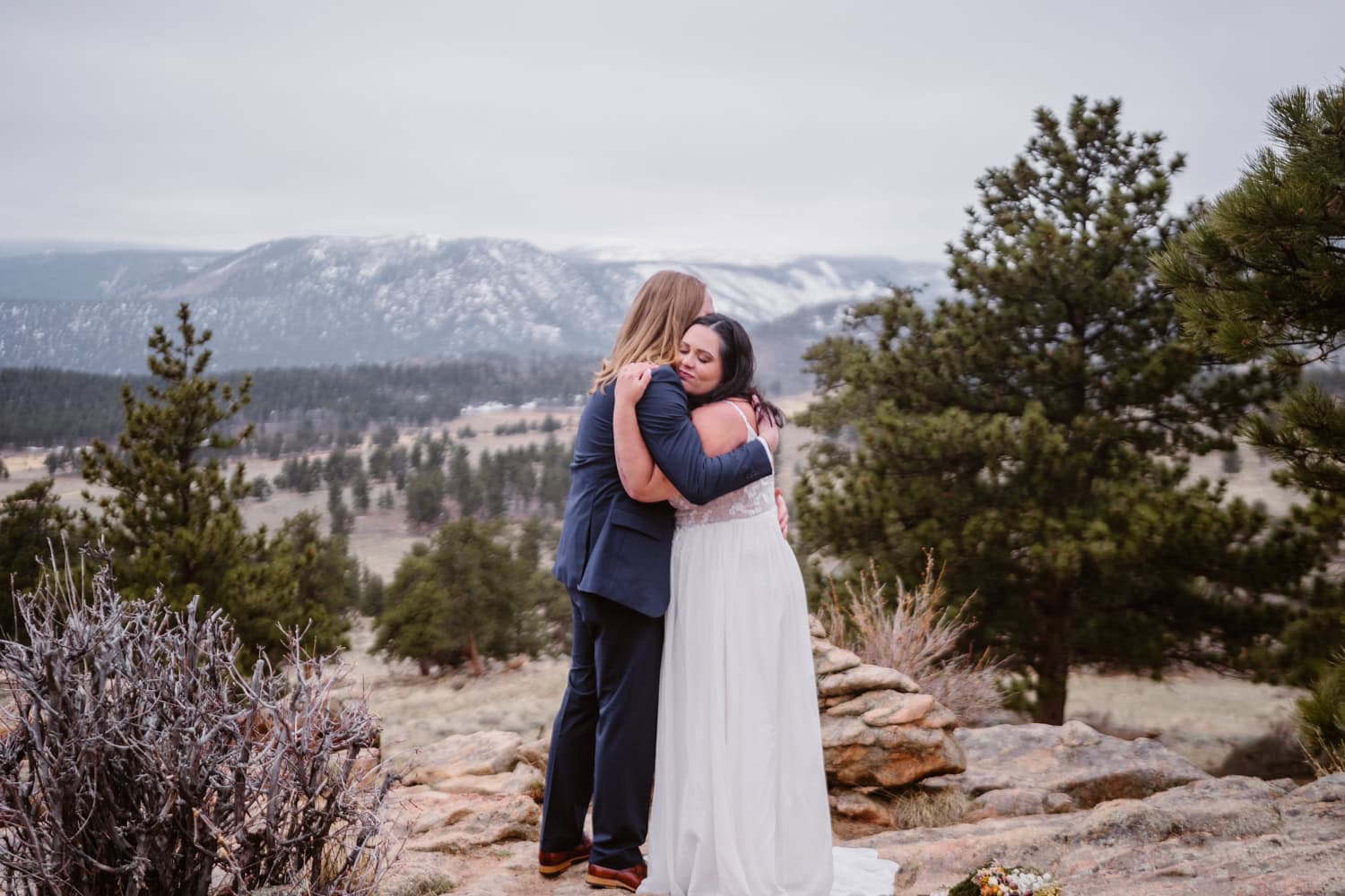 Couple sharing a hug at their Rocky Mountain National Park elopement.