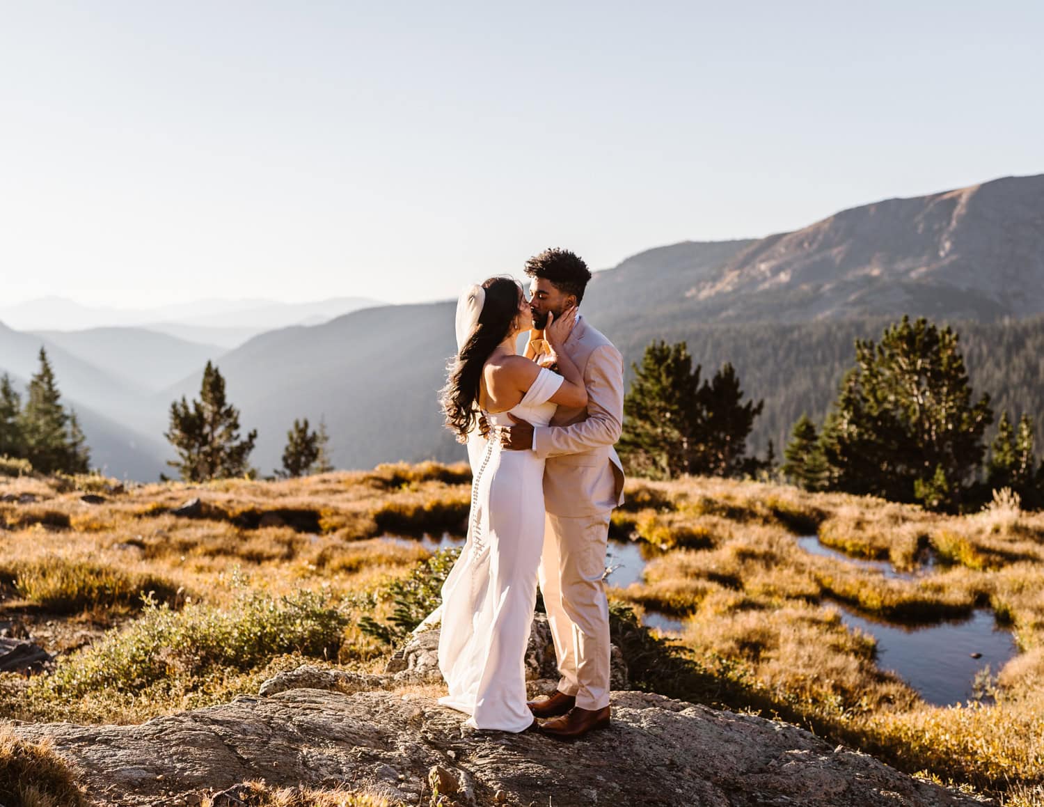 Bride and groom sharing a kiss at sunrise in Colorado