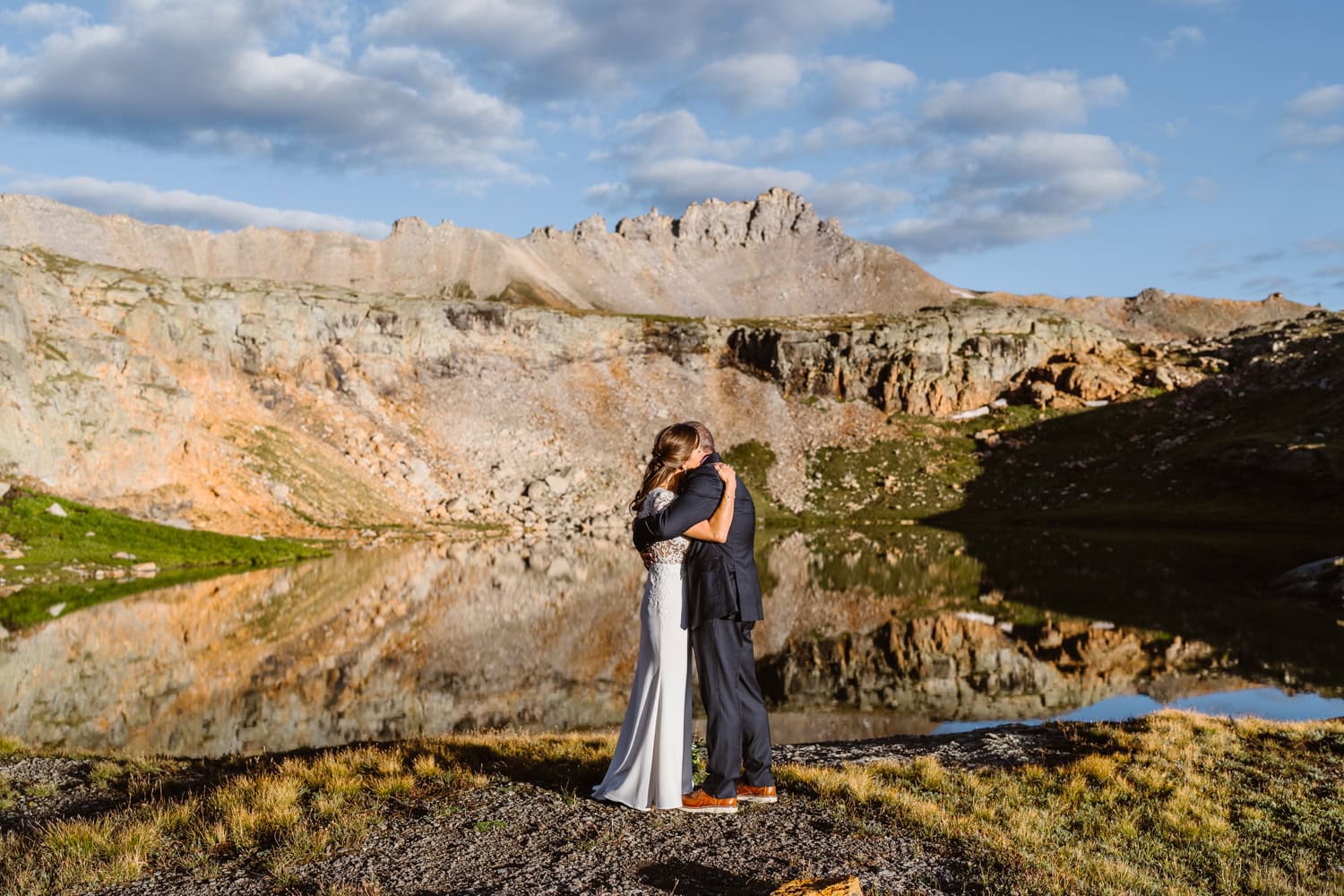 A couple sharing a hug at an alpine lake in Telluride for their elopement