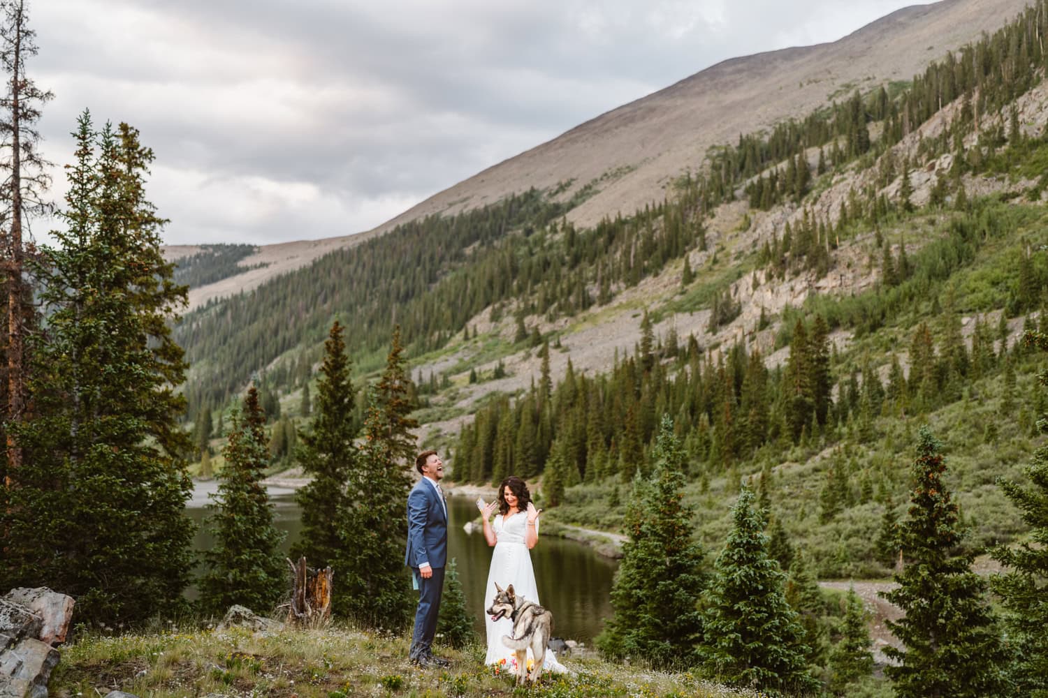 A couple sharing a moment with their dog during their Colorado elopement.
