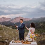 Couple spraying champagne at their elopement in Colorado.