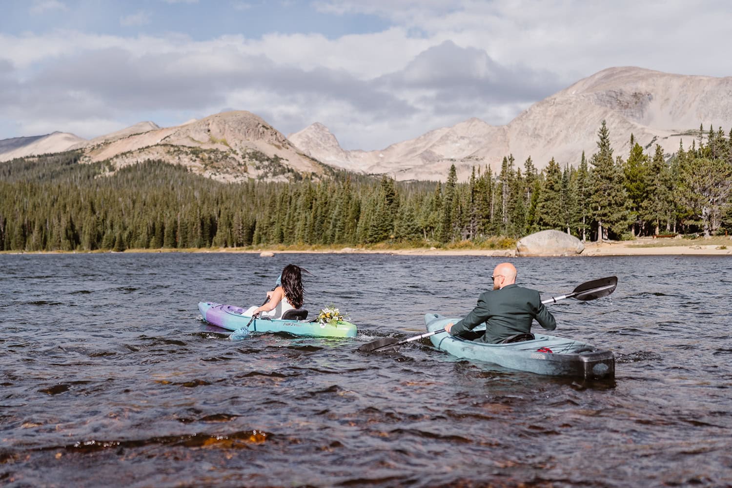 Bride and groom paddle boarding at Brainard Lake for their elopement day.